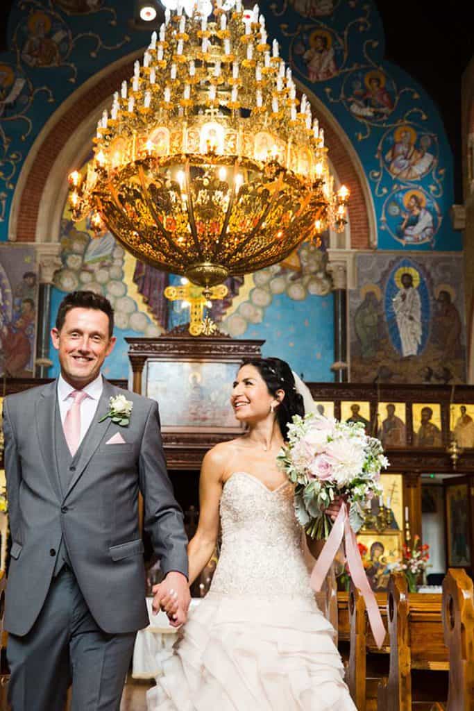 wedding-couple-marching-out-of-church-smiling-greek-orthodox-church-croydon