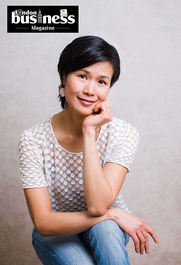 london-portrait-photography-london-business-magazine-article-female-photographer-in-white-top-blue-jeans-smiling