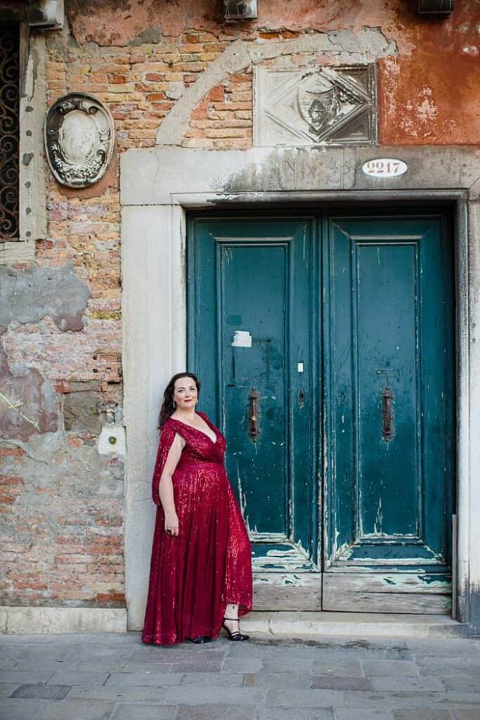 venice-dream-photo-shoot-woman-in-glamourous-red-dress-leaning-on-green-door