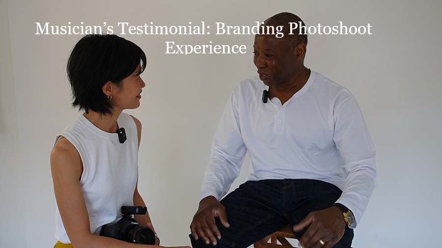 A photographer sits in conversation with a musician in a studio setting during a testimonial recording for portrait photographer London, both wearing microphones, with the text “Musician’s Testimonial: Branding Photoshoot Experience” above them.